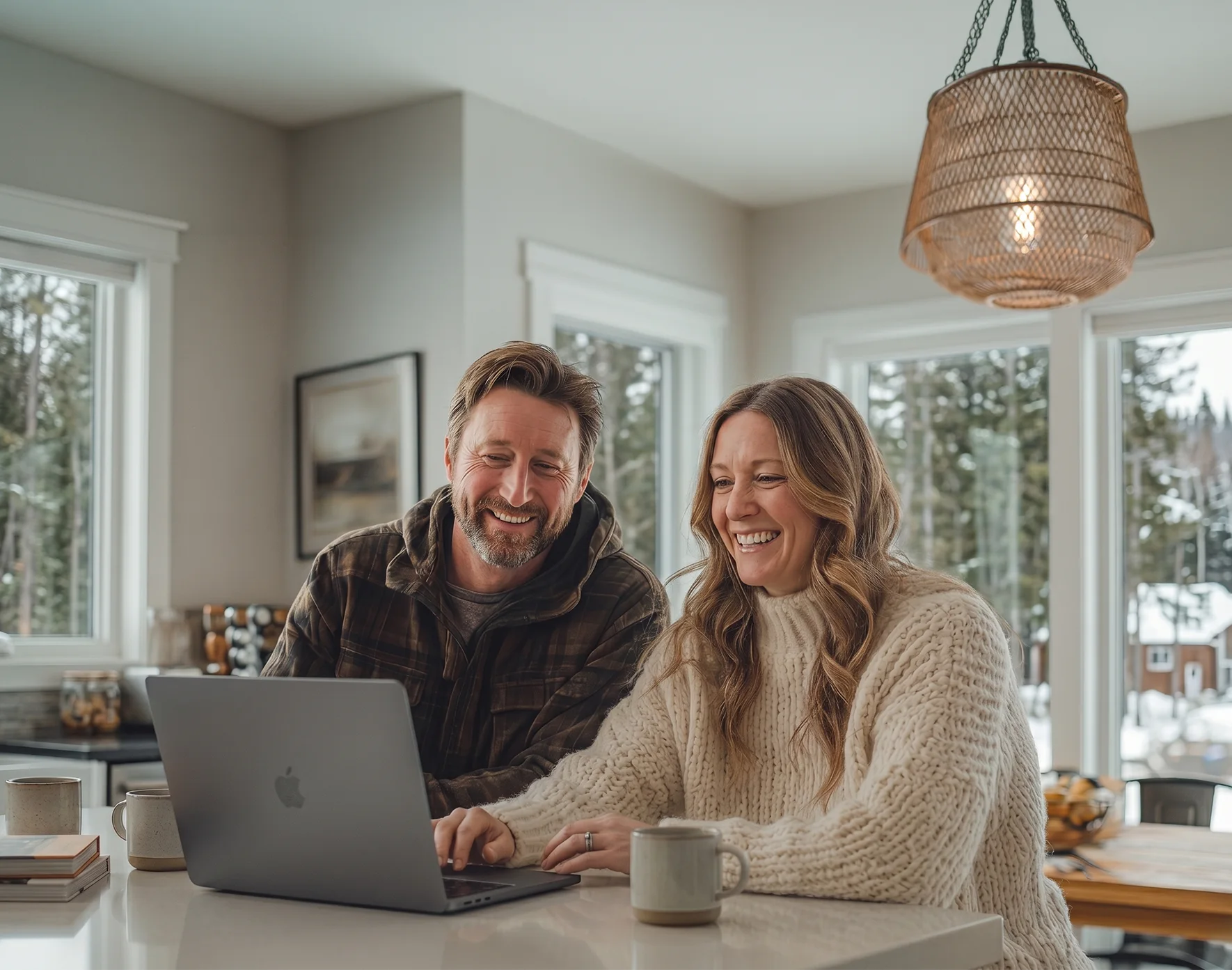 Happy couple browsing listings on laptop